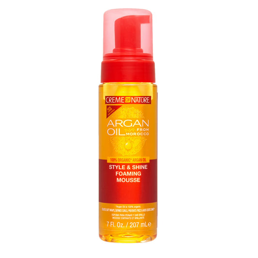 Creme of Nature Argan Oil Style and Shine foaming mousse in a clear foam pump bottle with red pump and white and red label text