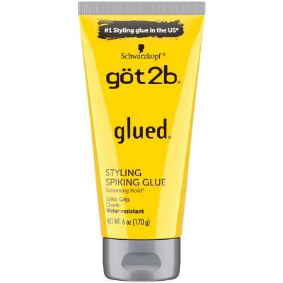 A yellow tube with black text of Got2B Glued Styling Spiking Glue that is water resistant for sleek hairstyles